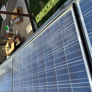 Residential Solar Panel Installation Above Backyard Deck