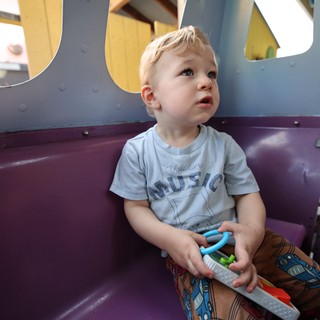 Young Child Gazing Upward in Colorful Play Area