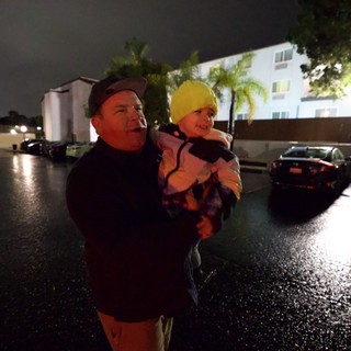 Father and Child During Nighttime Flood Emergency Evacuation