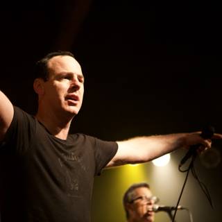 Entertainer in the Spotlight Caption: A singer commands the crowd with two microphones in hand during a solo performance at a Bad Religion concert in 2007.