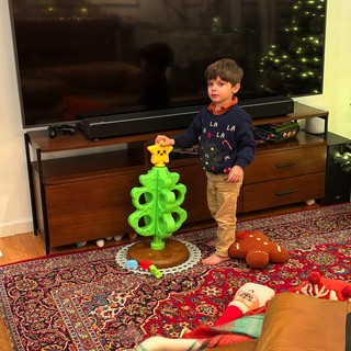 Young Boy Playing with Bright Green Toy Tower