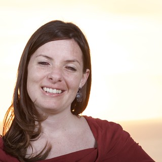Radiant Woman Smiling at Golden Hour Sunset