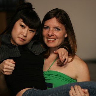 Two Friends Posing Together at Indoor Gathering