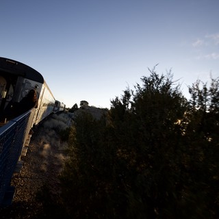 Scenic Train Journey Through Desert Landscape at Twilight