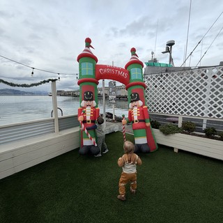 Children Exploring Inflatable Christmas Display by the Waterfront