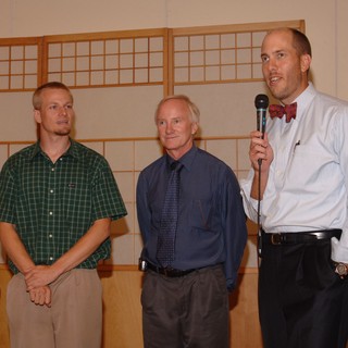 Three Men Share a Toast at Wedding Reception