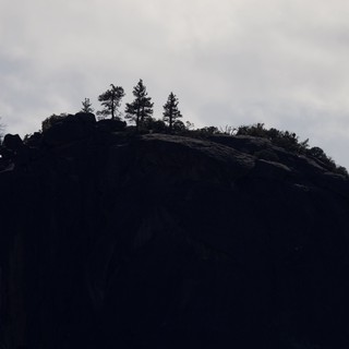 Silhouetted Rocky Summit Against Overcast Winter Sky