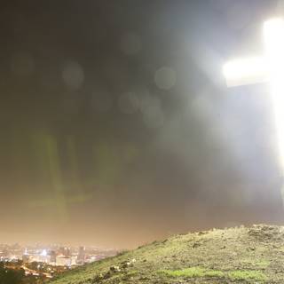 Cross atop the hill under the night sky