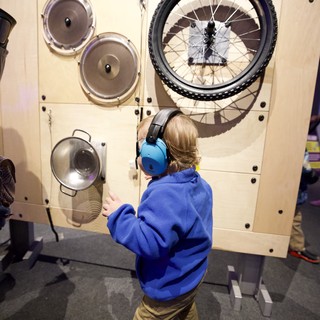 Child Explores Interactive Sound Exhibit at Museum