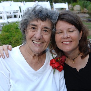 Two Women Share a Joyful Moment at Wedding