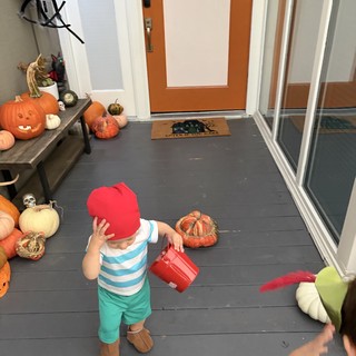 Toddler in Halloween Costume at Festive Front Porch