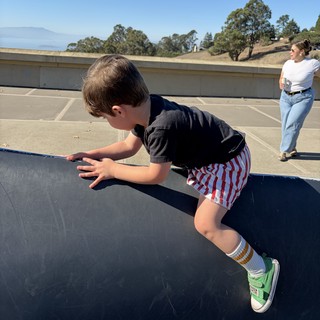 Young Boy Mid-Jump on Trampoline in California Backyard