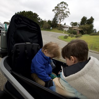 Children Share Tablet During Suburban Golf Cart Ride