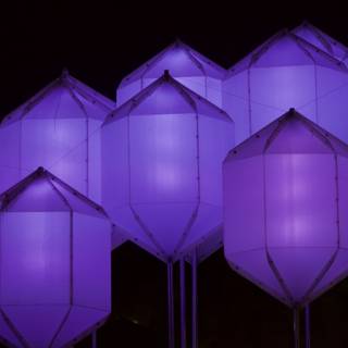 Illuminated Purple Kites Dance in the Night Sky