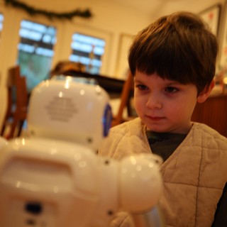 Young Boy Building White Robotic Toy at Home