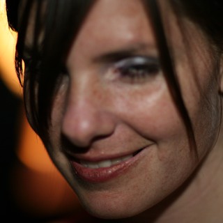 Candid Close-Up Portrait of Smiling Woman at Night