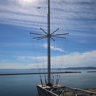 USS Hornet Aircraft Carrier Mast Against Coastal Sky