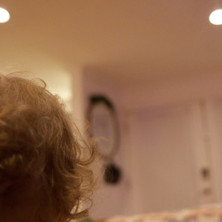 Curly-Haired Child Reading on Christmas Afternoon