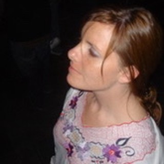 Young Woman Gazing Upward in Dark Setting
