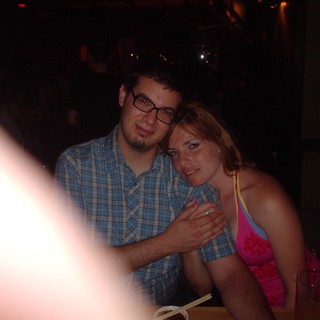 Couple Sharing a Close Moment at Dimly Lit Restaurant