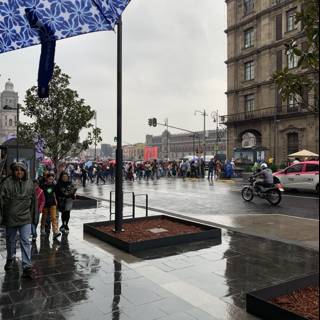 Blue Umbrella on a Crowded Sidewalk