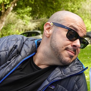 Man with Daisy on Sunglasses in Park