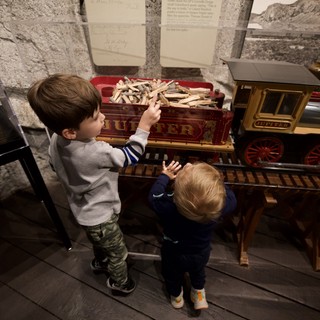 Children Exploring Historic Train Exhibit at Museum