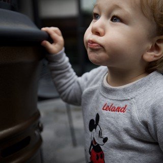 Curious Toddler in Mickey Mouse Sweatshirt Looking Up