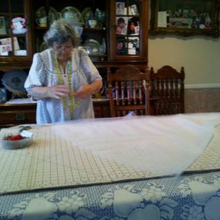 The Art of Linen: A Woman Cuts a Tablecloth