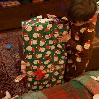 Child Opening Large Christmas Gift on Holiday Morning