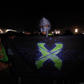 Masked DJ Peeks Over Exxion Banner at Wobbleland
