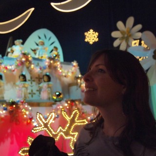 Woman Enjoying It's a Small World Holiday Display
