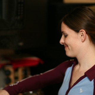 Woman in Profile Smiling Indoors at Night