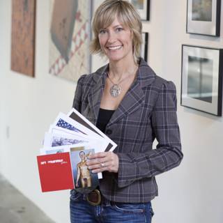 Woman with Folder in front of Artwork