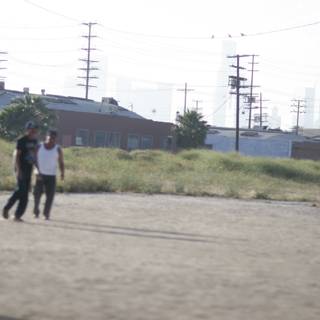 Group of 5 playing baseball in a dirt field