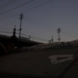 Dusk Train under the Freeway Bridge