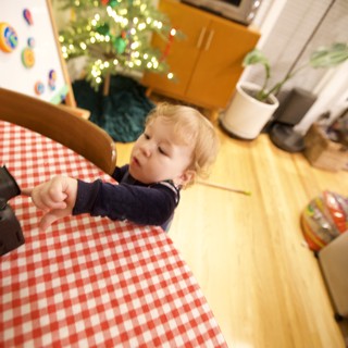 Toddler Helping Set Christmas Table in Kitchen