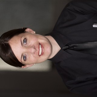 Professional Portrait of Smiling Woman in Black Uniform