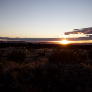 Desert Sunset Over Distant Mountain Ranges