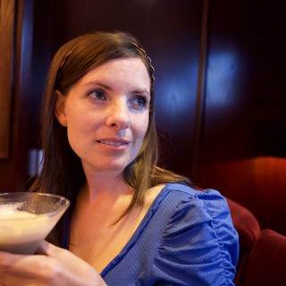 Woman Relaxing with Cocktail in Upscale Bar