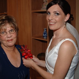 Bride Pins Corsage on Mother Before Wedding Ceremony