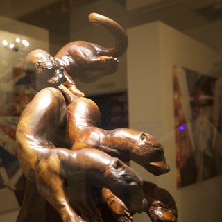 Bronze Sculpture of Playful Cats in Gallery