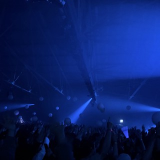 Skrillex Concert: Immersive Blue Light Show with Crowd