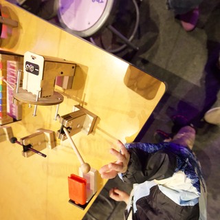 Overhead View of Young Person at Workspace with Miniature Office Setup
