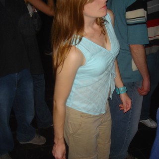 Young Woman Dancing at Dimly Lit Nightclub