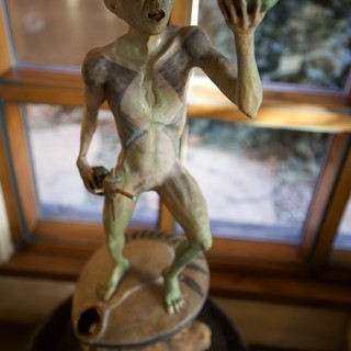 Alien Figure Sculpture Display in Interior Setting