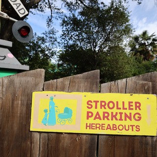 Vintage Stroller Parking Sign at Railroad Crossing