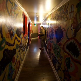 Vibrant Mural-Covered Hallway in Historic Building
