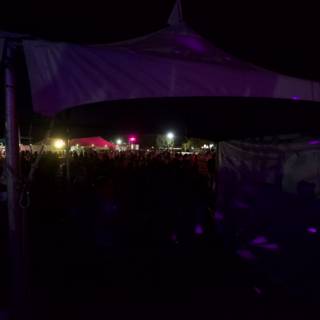 Nighttime Concert Crowd under Tent