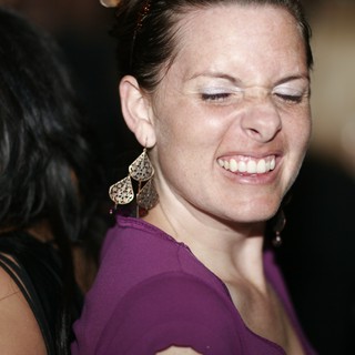 Joyful Woman Laughing at Nighttime Social Event